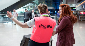 daa staff pink bib helping passenger