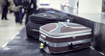 small suitcase on security conveyor belt