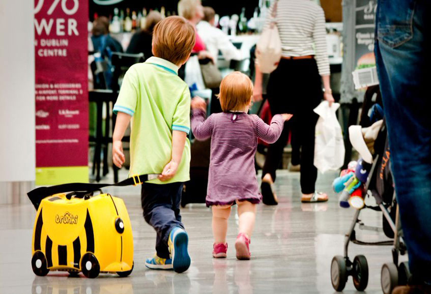 toddlers with suitcase travelling with children 