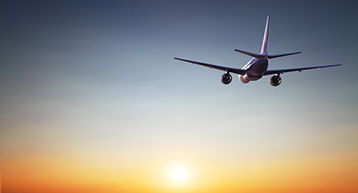 plane in midflight at sunset 